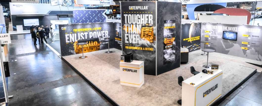 Black-and-grey Caterpillar defence stand with engine graphics and product screens at Euronaval 2024 in Paris