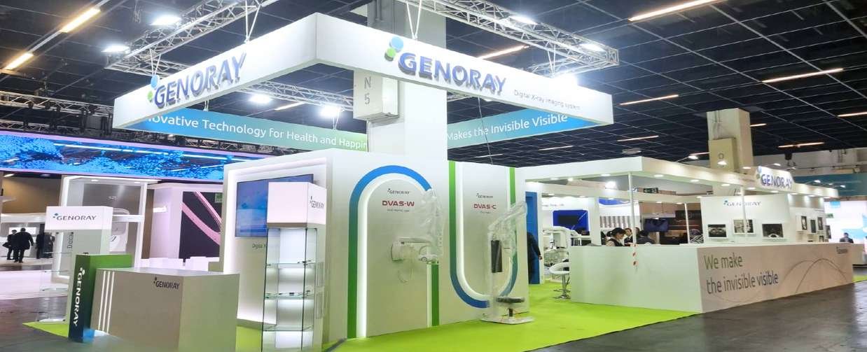 White-and-green Genoray stand displaying dental imaging equipment at IDS in Cologne