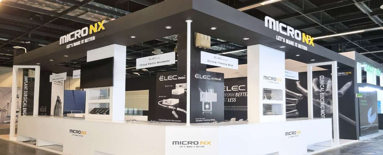 Black-and-white MicronX stand displaying dental micromotors at IDS in Cologne